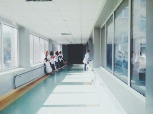Doctors standing in a bright hospital hallway.