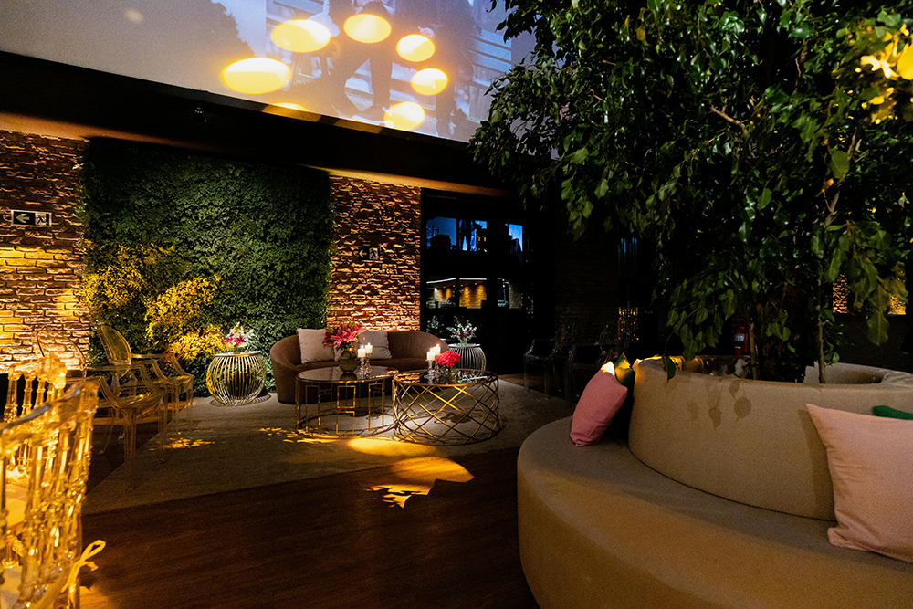 Elegant hotel lounge with greenery, warm lighting, and modern seating