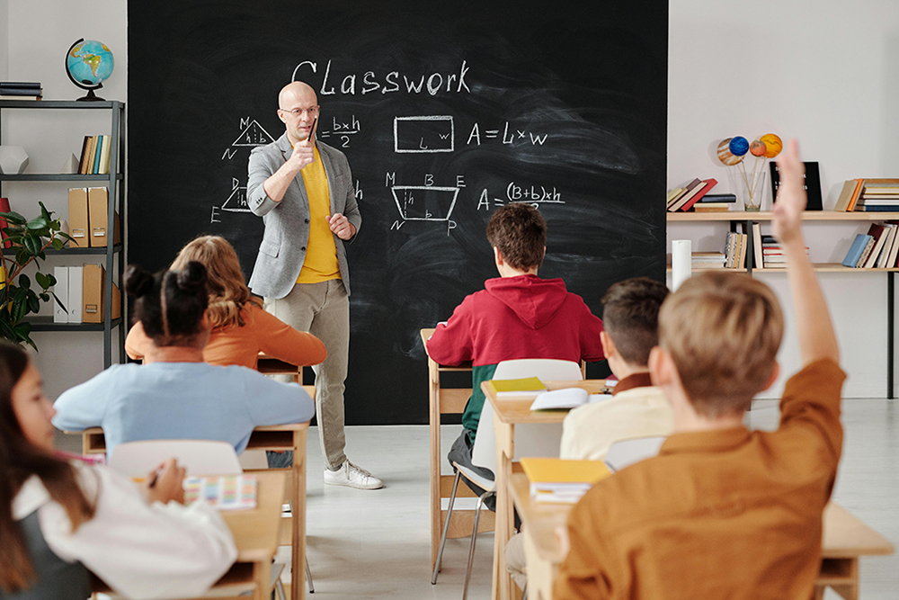 Teacher giving a math lesson to students in a classroom
