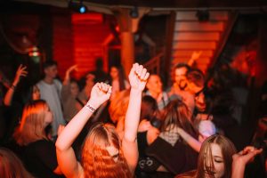 Guests dancing in a club, illustrating how clean air improves comfort and atmosphere.