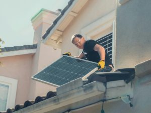 Worker installing a solar panel