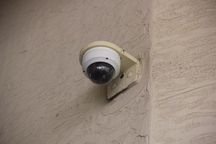 Standard dome surveillance camera mounted outdoors, showing older single-sensor coverage.