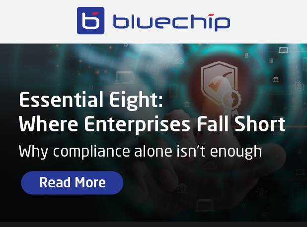 promotional graphic titled 'Essential Eight: Where Enterprises Fall Short' with the subtitle 'Why compliance alone isn't enough' and a 'Read More' link.