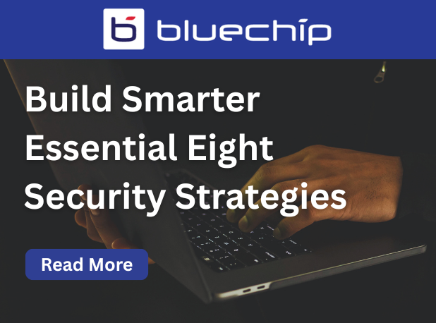 Bluechip banner promoting Essential Eight security strategies with a person typing on a laptop
