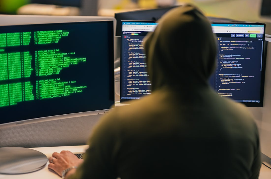 Cybersecurity professional monitoring system activity to prevent cyber threats.