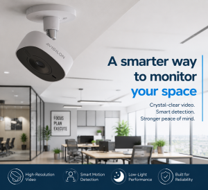 Avigilon Flex Cloud Camera mounted on a modern office ceiling overlooking a sleek meeting and lounge area with natural lighting and contemporary interior design.